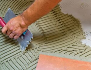 Perth handyman skillfully installing tiles and flooring materials, ensuring durable, attractive, and level surfaces for residential and commercial properties, enhancing their aesthetic appeal and functionality.