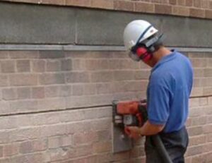 expertly repairing a cracked wall using the Helifix system, a reliable and non-disruptive solution that restores structural stability and appearance to damaged masonry in residential and commercial buildings.
