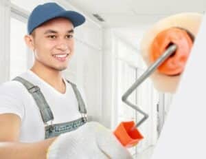 Perth-based handyman expertly painting a residential wall with a roller, showcasing precise technique and attention to detail while providing top-notch home improvement services.