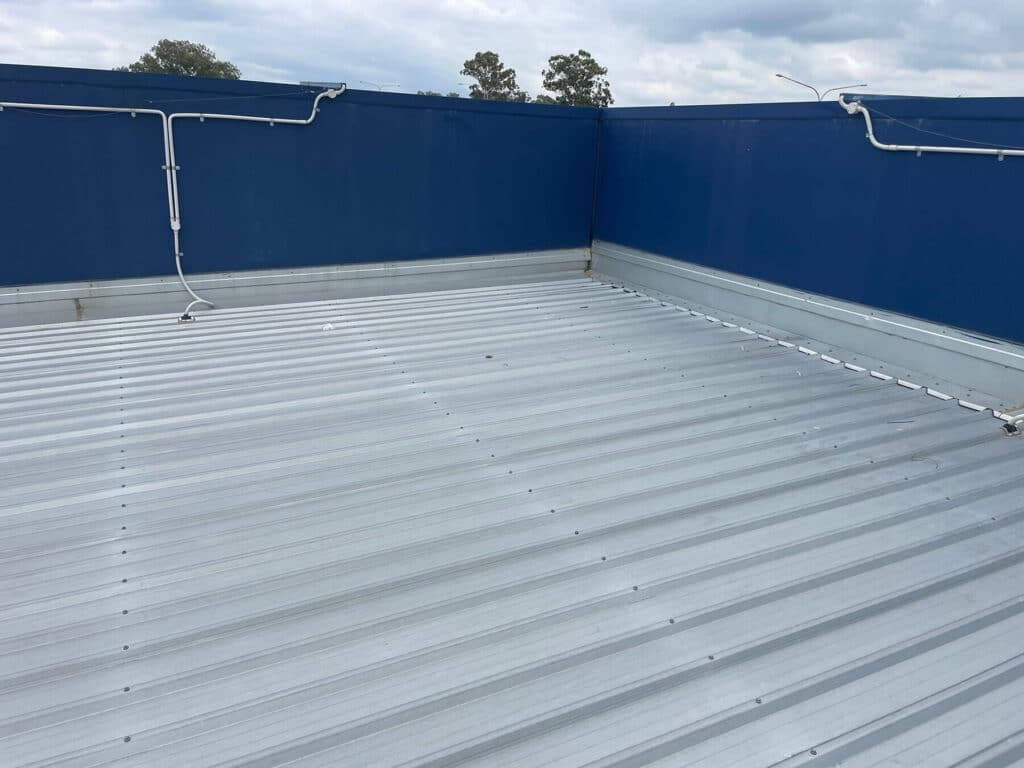 Flat metal roof with a corrugated surface